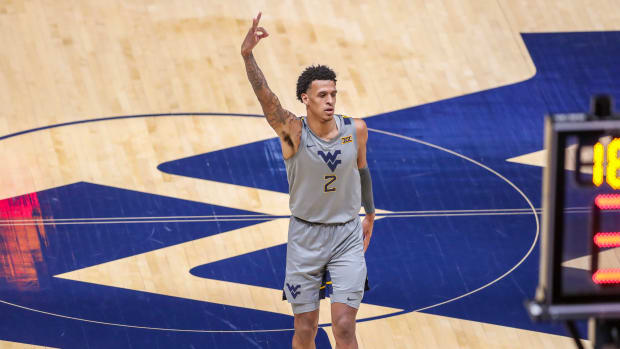 Feb 6, 2021; Morgantown, West Virginia, USA; West Virginia Mountaineers forward Jalen Bridges (2) celebrates a made three pointer during the first half against the Kansas Jayhawks at WVU Coliseum. Mandatory Credit: Ben Queen-USA TODAY Sports